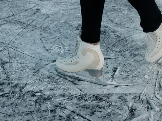 Snowy adventures on winter holidays in the Alps White ice skates on a scratched ice surface