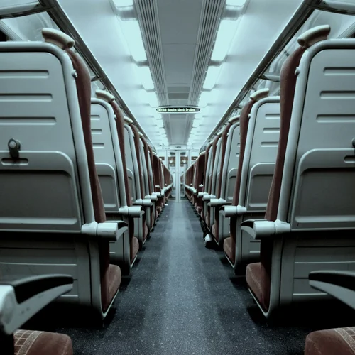 Your cosy retreats: rooms and suites at the Weisskugel Empty train carriage with rows of seats and a central aisle