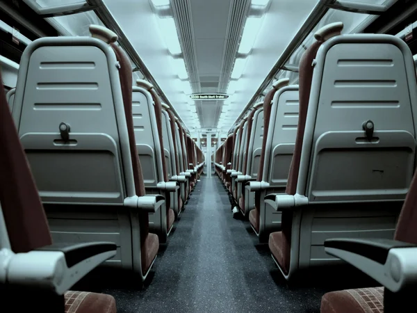 Your cosy retreats: rooms and suites at the Weisskugel Empty train carriage with rows of seats and a central aisle