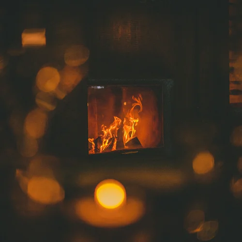 Gasthof Weisskugel in Vent: family-run since the beginning Burning fireplace in a dimly lit room with a cozy atmosphere