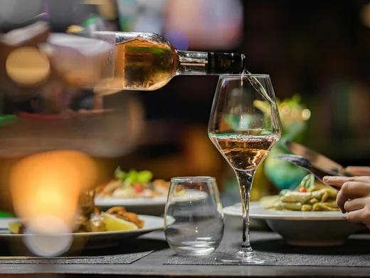 Weisskugel: your accommodation in Tyrol Wine being poured into a glass at a set restaurant table