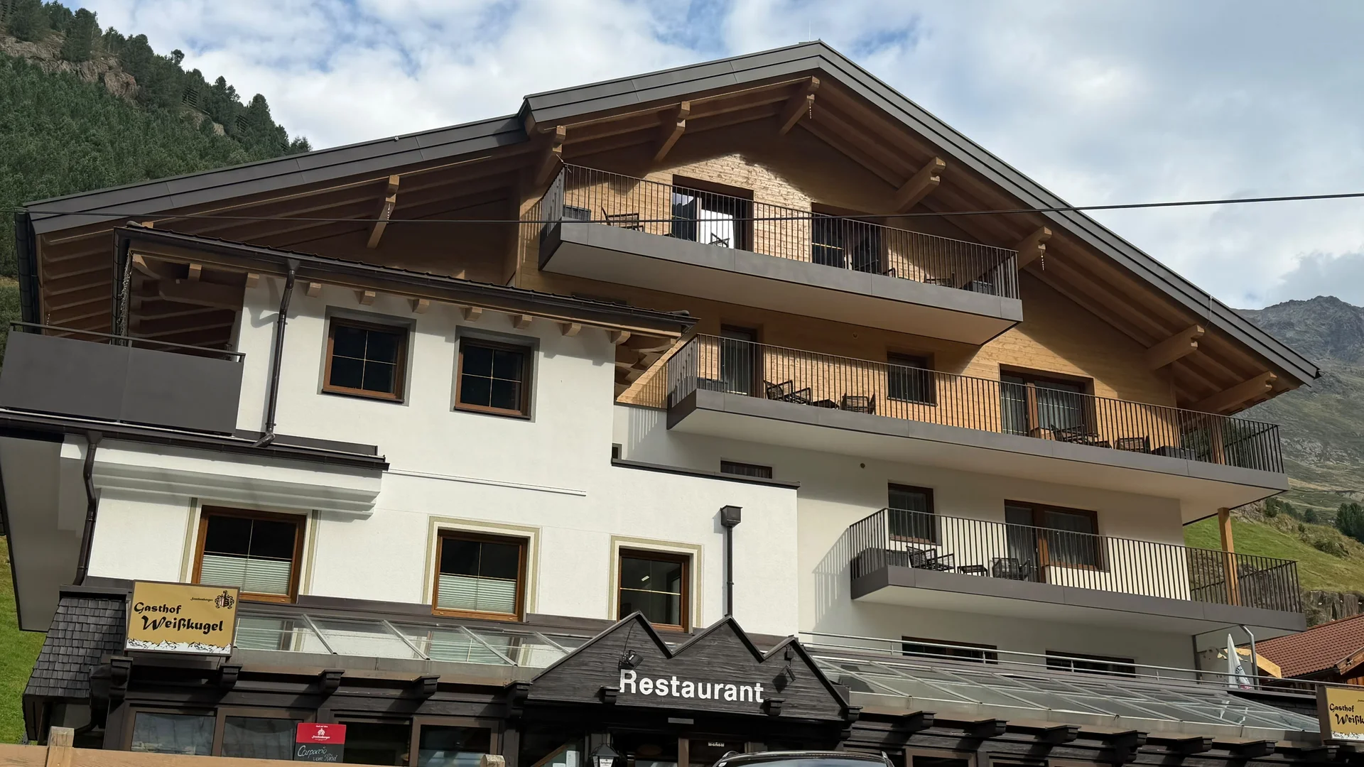 Weisskugel: your accommodation in Tyrol Building with balconies and restaurant in a mountain landscape