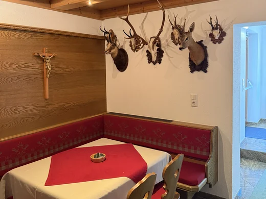 Gasthof Weisskugel: your authentic restaurant in Vent Rustic dining nook with set table, wood ceiling and trophies on the wall
