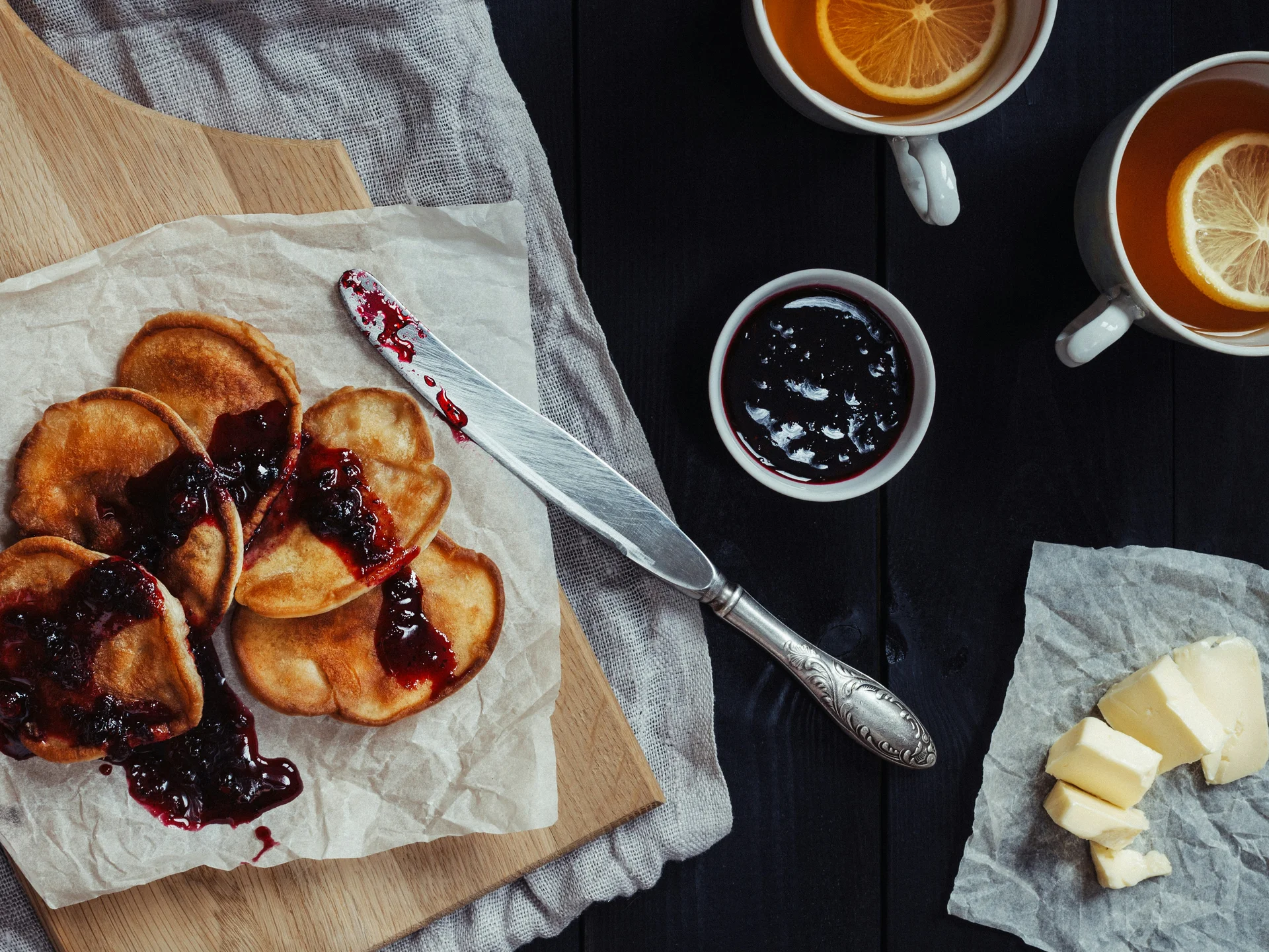 Gasthof Weisskugel: your authentic restaurant in Vent Pancakes with berry jam, tea with orange slices and butter on a table