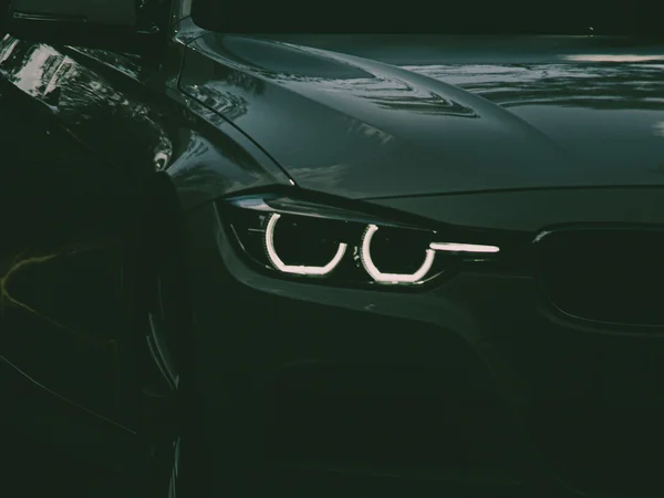 Your cosy retreats: rooms and suites at the Weisskugel Close-up of the front of a dark car with illuminated headlights